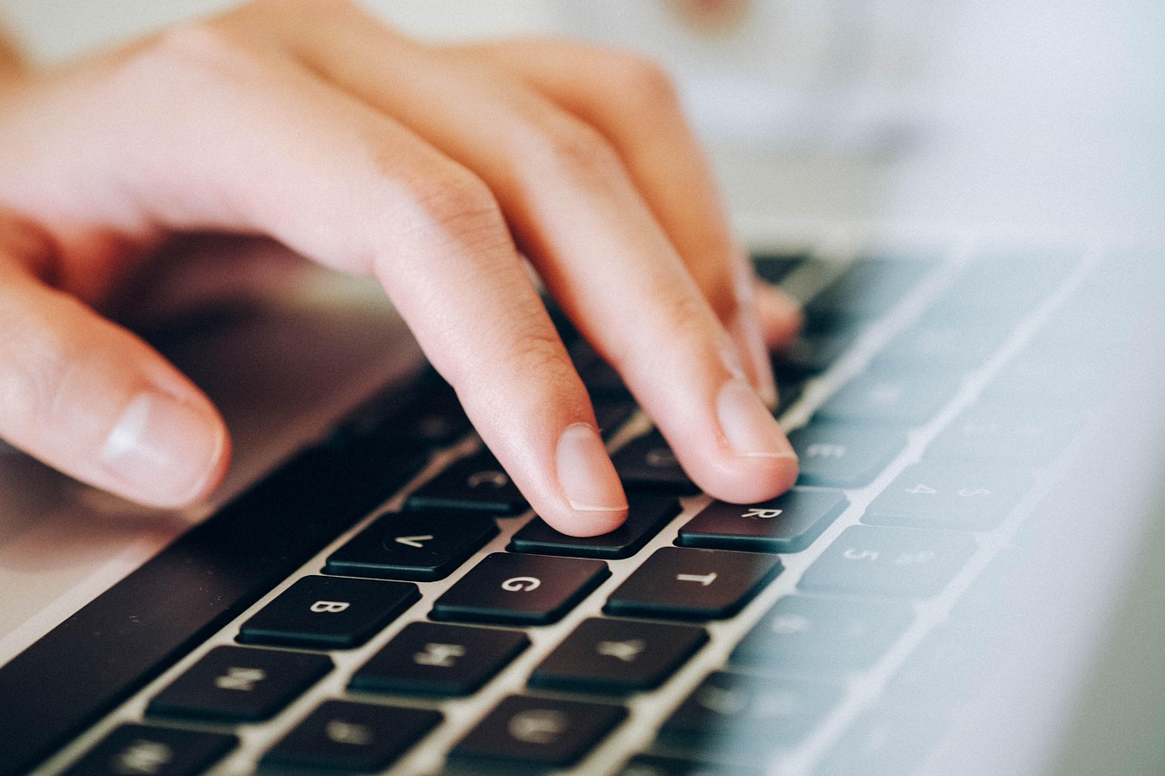 An Image showing a lady writing an article on her pc